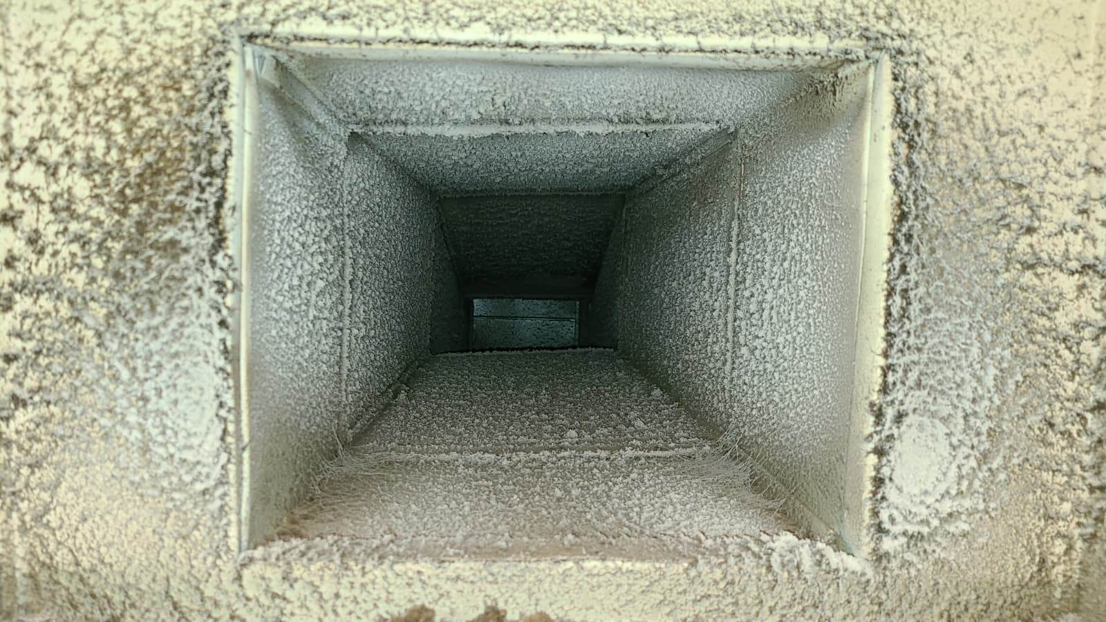 REMOVING HEAVY DUST BUILDUP FROM INSIDE THE AIR DUCT.